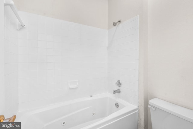 bathroom with bathing tub / shower combination and toilet