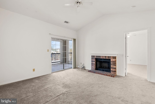 unfurnished living room featuring ceiling fan, carpet flooring, vaulted ceiling, and a brick fireplace