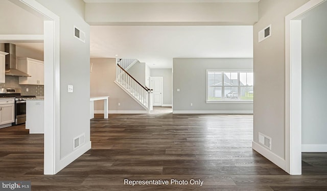 unfurnished living room featuring dark wood-type flooring