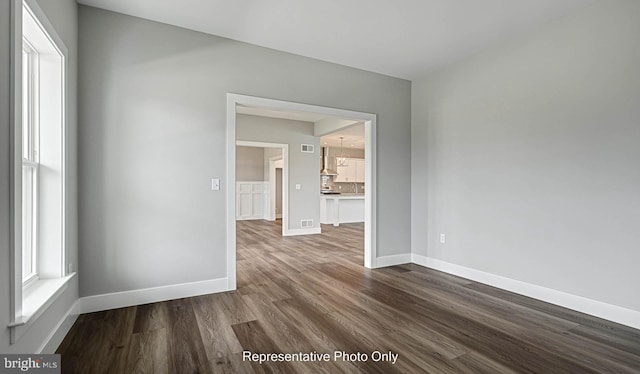 unfurnished room featuring dark hardwood / wood-style floors