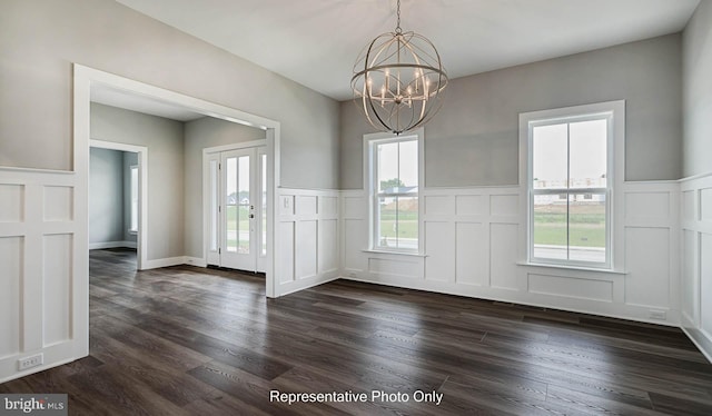 unfurnished dining area featuring dark hardwood / wood-style floors and a notable chandelier