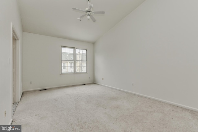 carpeted spare room featuring ceiling fan and high vaulted ceiling