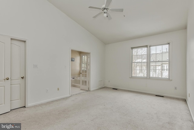 unfurnished bedroom with ceiling fan, light colored carpet, and high vaulted ceiling