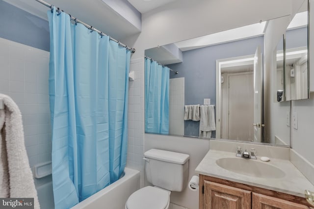 full bathroom featuring toilet, vanity, and shower / tub combo with curtain