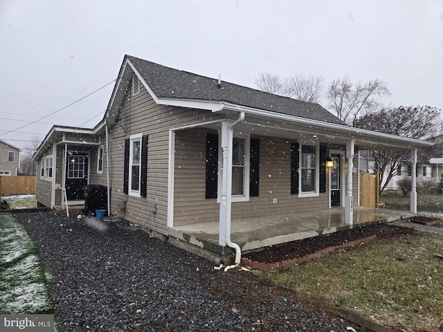 view of side of home with covered porch