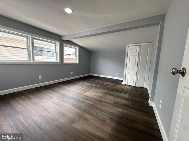 bonus room featuring dark hardwood / wood-style floors and vaulted ceiling