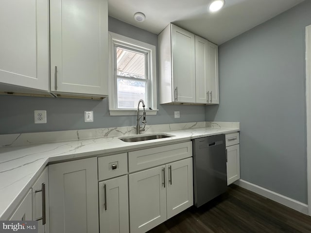 kitchen featuring white cabinets, dishwasher, light stone counters, and sink