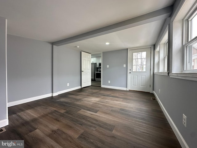 interior space featuring beam ceiling and dark hardwood / wood-style flooring