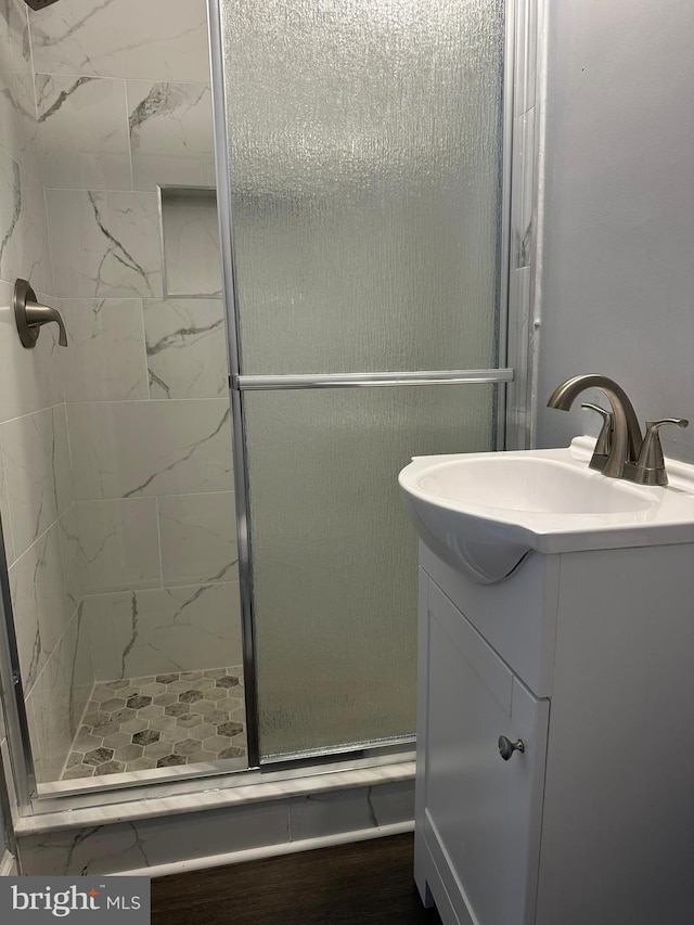 bathroom with vanity and a shower with door