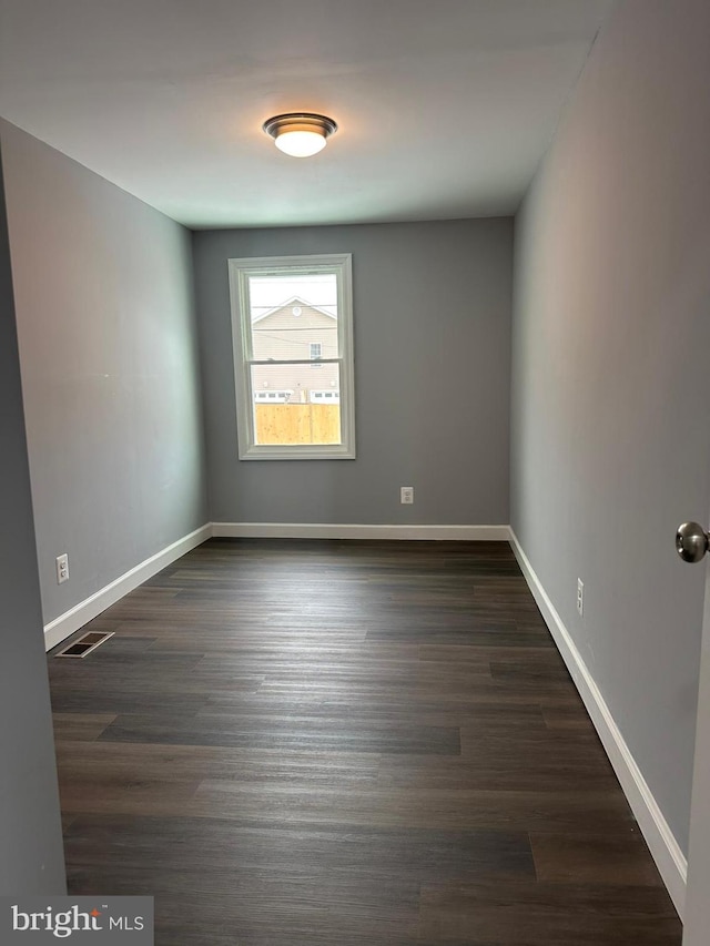 spare room featuring dark hardwood / wood-style floors