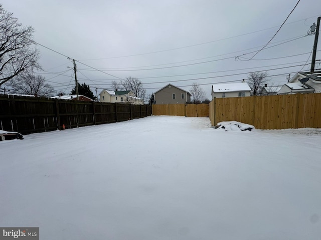 view of yard layered in snow