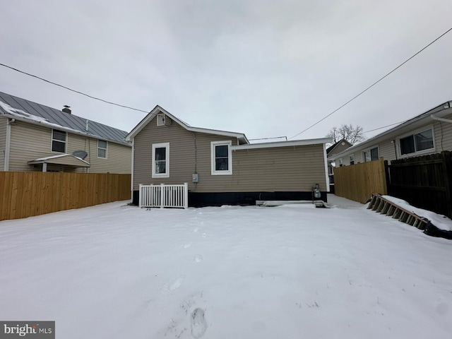 snow covered property featuring central AC