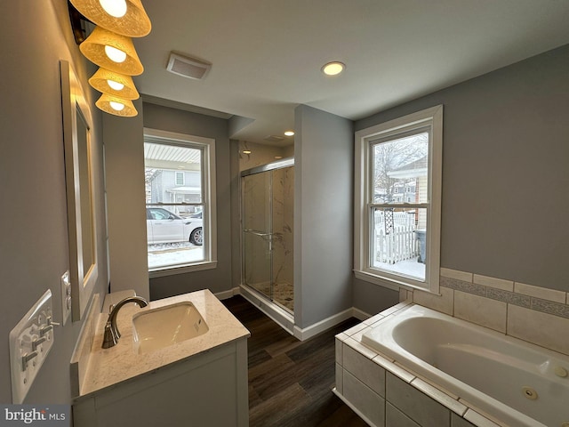 bathroom featuring hardwood / wood-style floors, vanity, and independent shower and bath