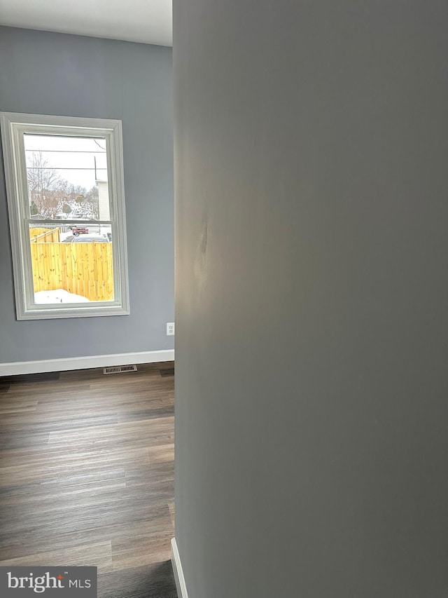 unfurnished room featuring dark hardwood / wood-style floors