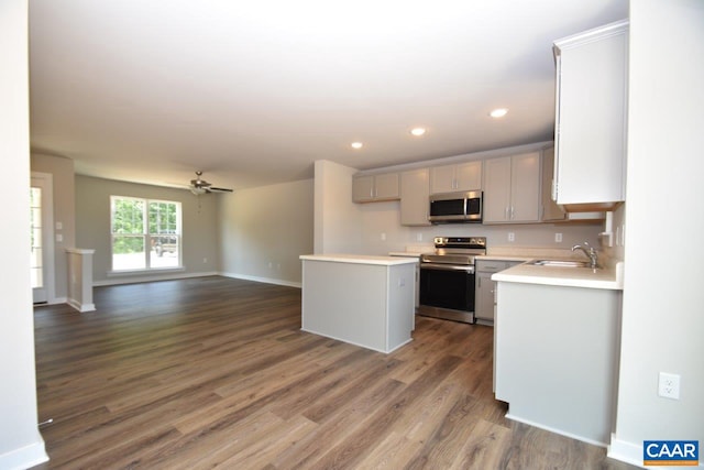 kitchen featuring gray cabinetry, sink, dark hardwood / wood-style floors, and appliances with stainless steel finishes