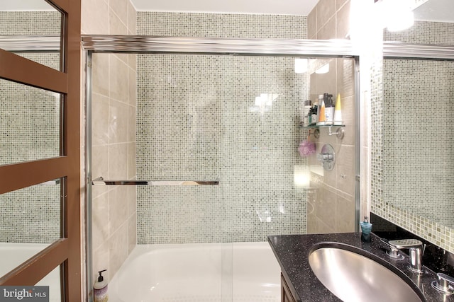 bathroom with combined bath / shower with glass door and vanity