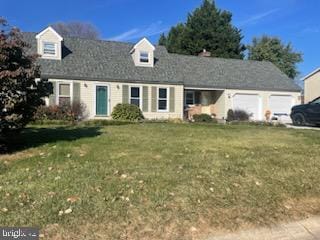 view of front of property with a front yard and a garage