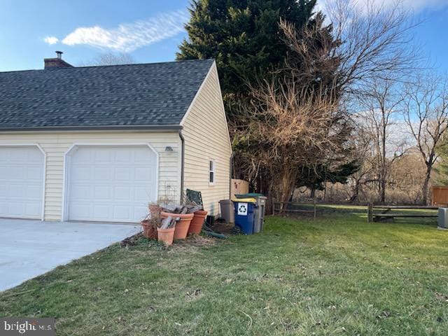 view of home's exterior featuring a yard and a garage