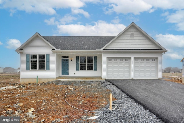 single story home featuring a porch and a garage