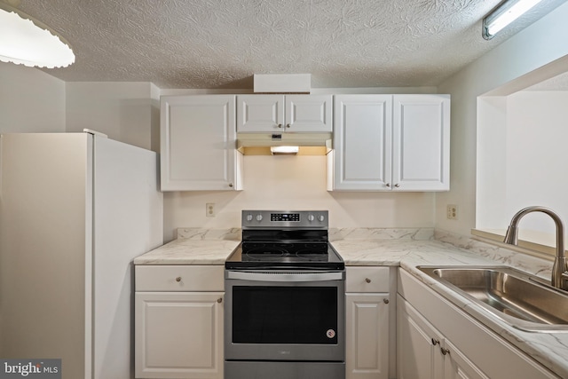 kitchen with stainless steel range with electric cooktop, white refrigerator, white cabinetry, and sink