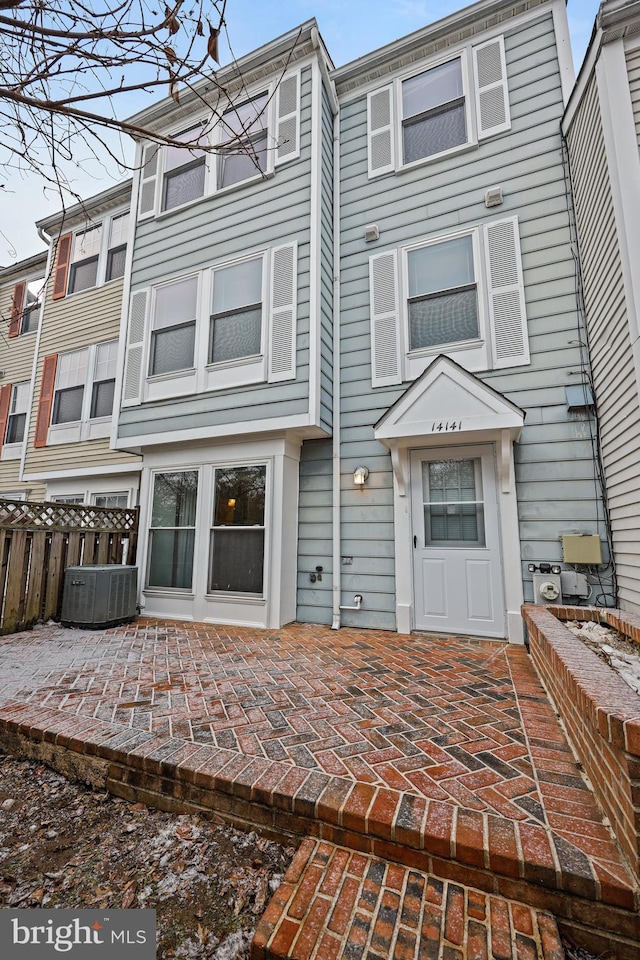 back of property featuring central AC unit and a patio area