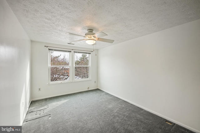 empty room with ceiling fan, a textured ceiling, and carpet flooring