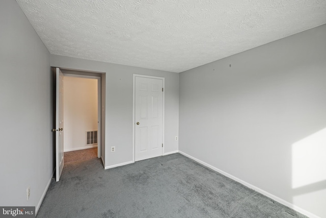 unfurnished bedroom with carpet and a textured ceiling