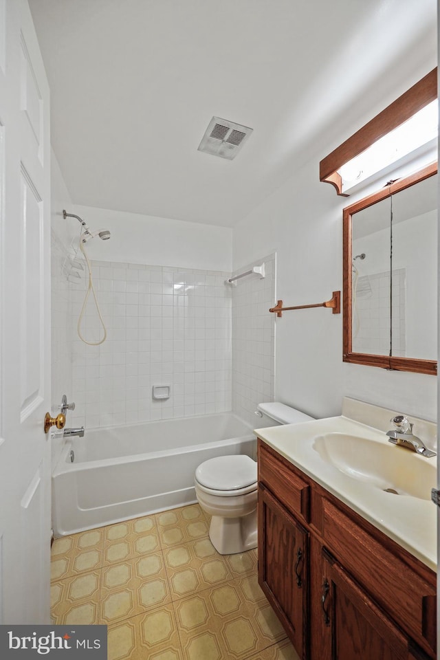 full bathroom with toilet, tiled shower / bath, and vanity