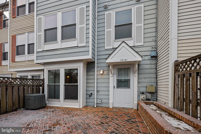 doorway to property featuring central AC unit and a patio area