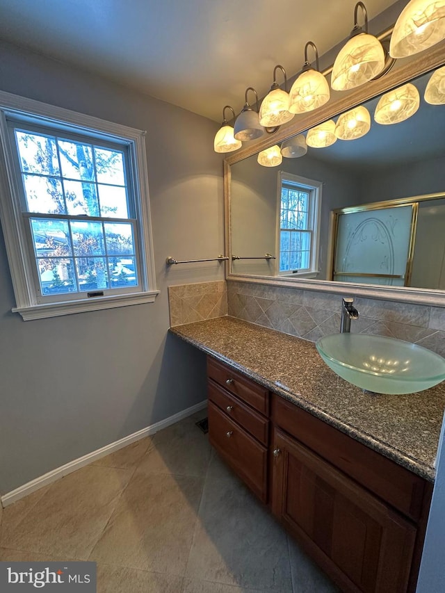 bathroom featuring tile patterned floors, backsplash, and vanity