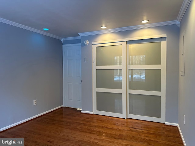 unfurnished room featuring ornamental molding and hardwood / wood-style flooring