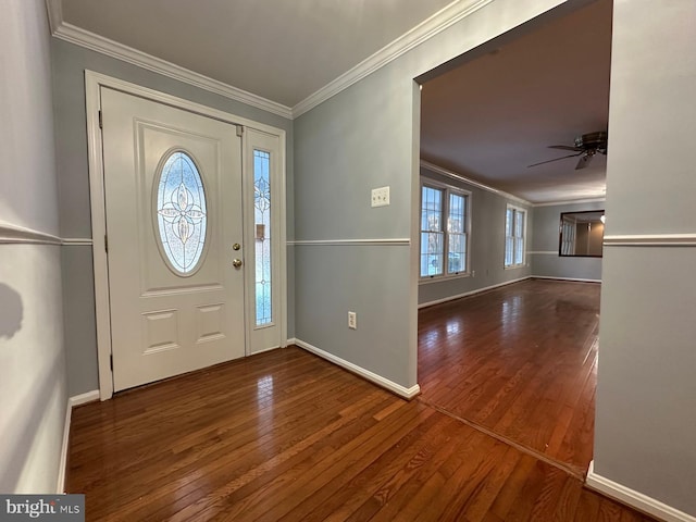 entrance foyer with ceiling fan, dark wood-type flooring, and ornamental molding