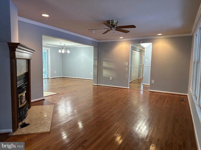 unfurnished living room featuring a fireplace, ornamental molding, ceiling fan with notable chandelier, and hardwood / wood-style flooring