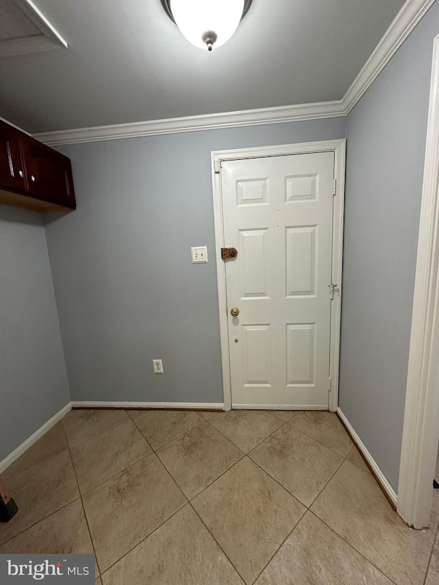 foyer entrance featuring light tile patterned floors and ornamental molding