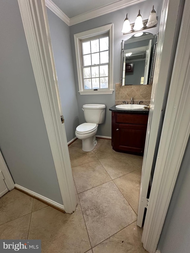 bathroom with tile patterned flooring, vanity, backsplash, toilet, and ornamental molding