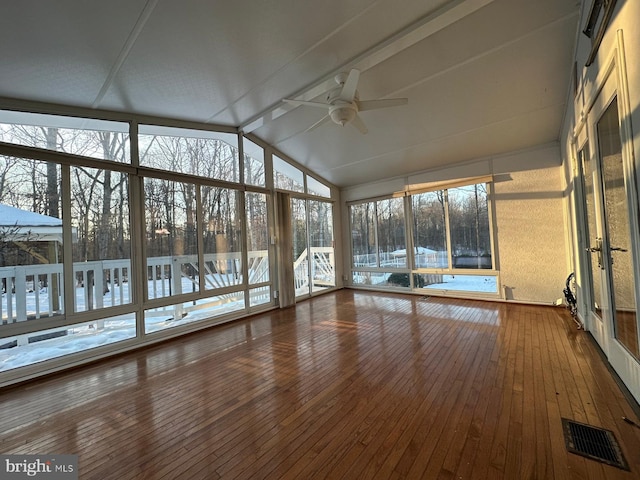 unfurnished sunroom with ceiling fan and vaulted ceiling