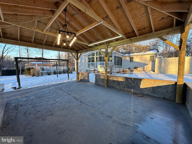 snow covered patio featuring an outbuilding