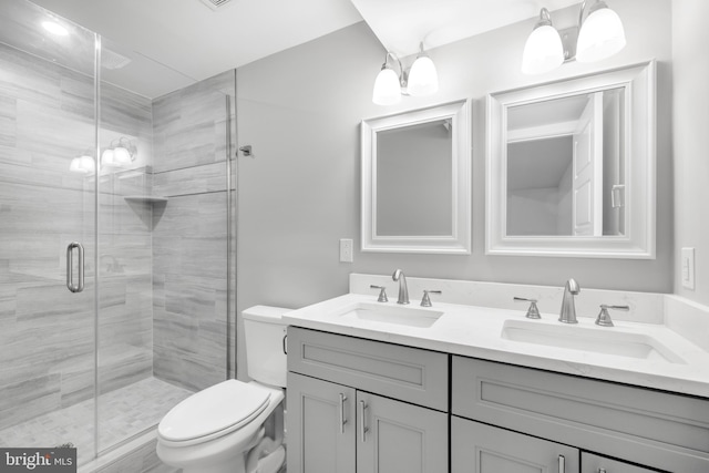 bathroom featuring walk in shower, vanity, and toilet