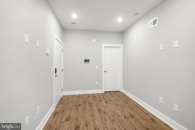 hallway with light hardwood / wood-style floors