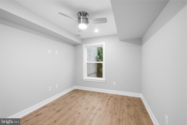 empty room with ceiling fan and light hardwood / wood-style flooring