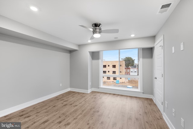 spare room with ceiling fan and light hardwood / wood-style flooring