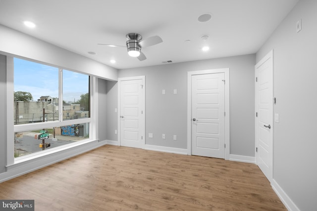 unfurnished bedroom with wood-type flooring and ceiling fan