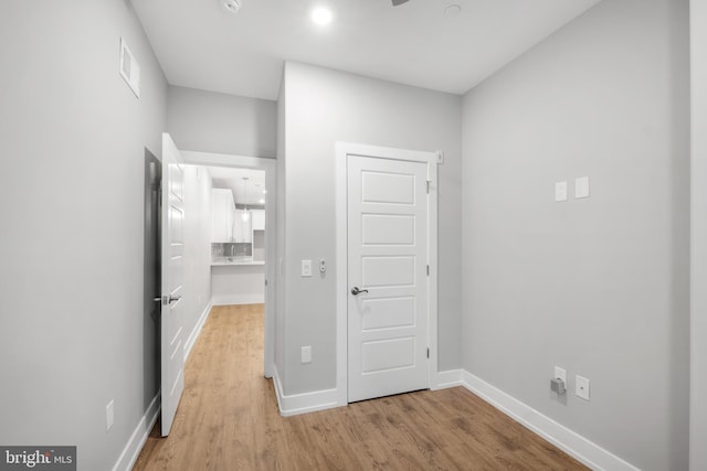 corridor featuring light hardwood / wood-style floors