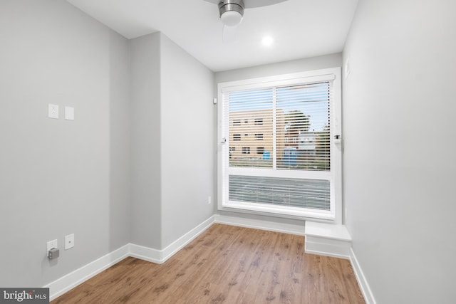 empty room with ceiling fan and light wood-type flooring