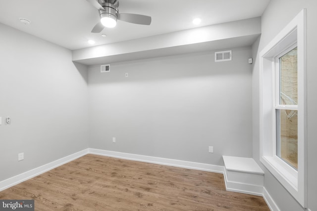 empty room with hardwood / wood-style flooring, ceiling fan, and a wealth of natural light