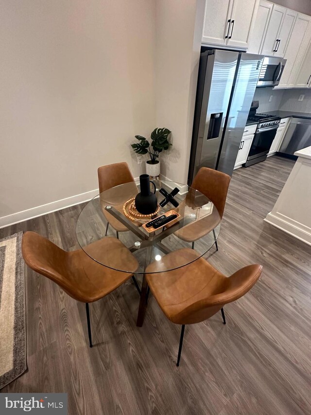 dining area featuring dark hardwood / wood-style flooring