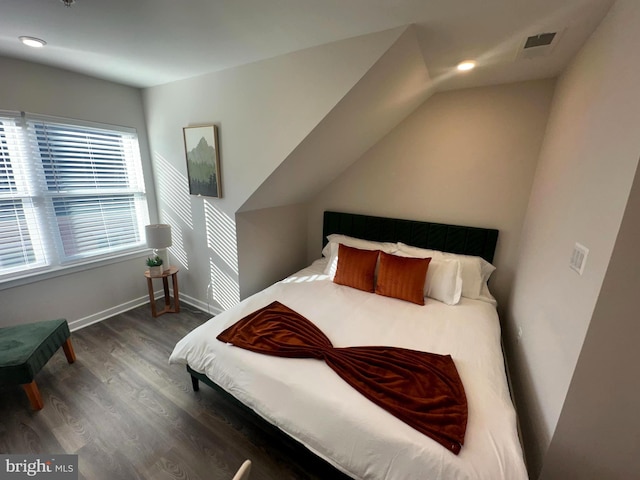 bedroom featuring dark wood-type flooring and vaulted ceiling