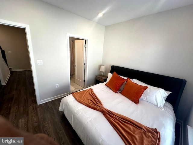 bedroom with dark hardwood / wood-style flooring