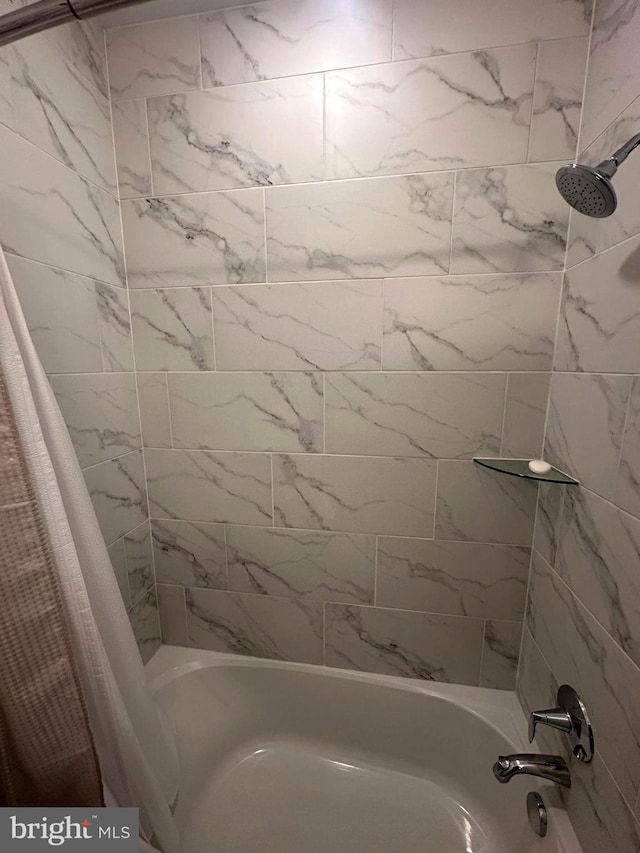 bathroom with shower / bath combination with curtain