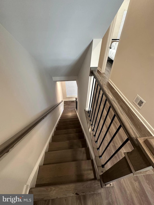 stairs featuring hardwood / wood-style floors